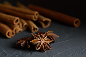  shelves of cinnamon and anise stars in dark colors on a dark concrete stone background