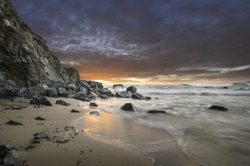 Fototapeta na wymiar Natural rocks in the sea with beautiful sunset sky on the beach of Silistar, Bulgaria