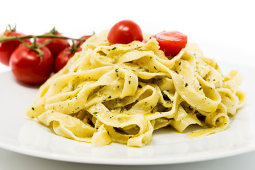 Pasta with pesto sauce and nuts on a the table