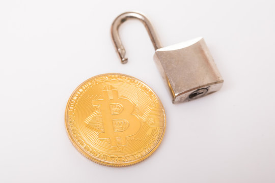 Golden bitcoin with a open lock isolated on white background