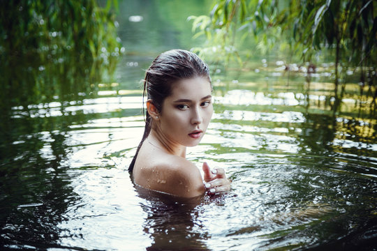 Beautiful young girl resting in water