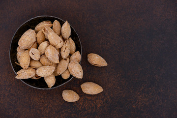 Almonds nuts on bowl. Top view