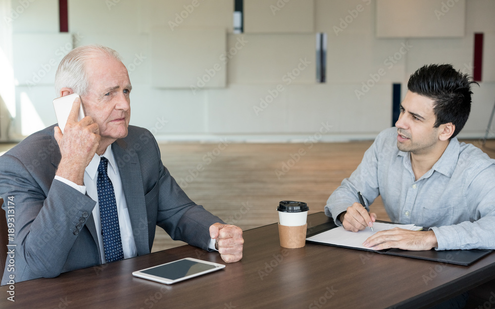 Wall mural Disappointed manager talking to business partner