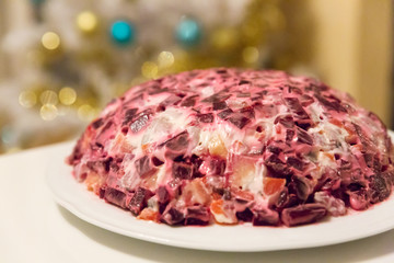 russian salad pod shuba herring under fur coat in front of a white christmas tree