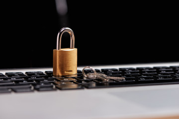 Computer security and data protection concept. Laptop with an locked lock on it. © makistock