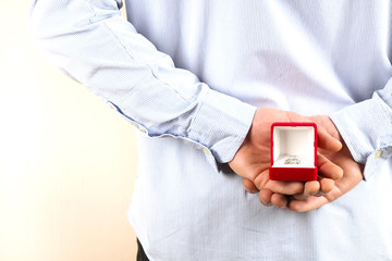 Engagement / marriage / wedding proposal scene. Close up of man handing the expensive gold platinum diamond ring to his bride.