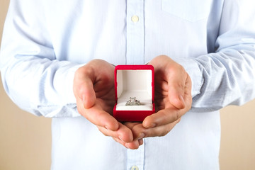 Engagement / marriage / wedding proposal scene. Close up of man handing the expensive gold platinum diamond ring to his bride.