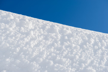 white snow surface and blue sky. Winter day.