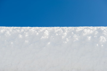 white snow surface and blue sky. Winter day.