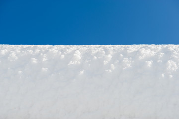 Obraz premium white snow surface and blue sky. Winter day.