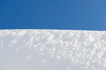 white snow surface and blue sky. Winter day.