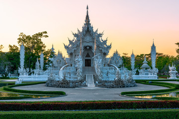 Wat Rong Khun(White temple)at sunset in Chiang Rai,Thailand.23/01/2018 Wat Rong Khun is modern building, well known worldwide.It was designed by Chalermchai Kositpipat.Opened it to visitors in 1997.