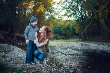 Fototapeta premium A series about happy red-haired. The elder sister and younger brother and sister. Park, autumn, river