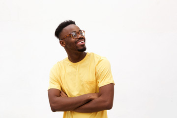 handsome young black man smiling with glasses against white background