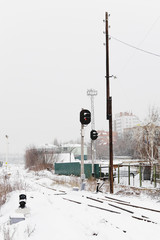 Winter railway. Railway traffic light. Vertical photography.