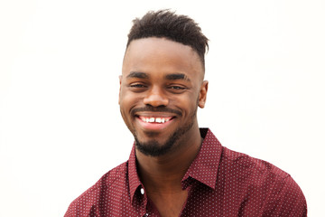 Obraz premium Close up happy young african man smiling against isolated white background