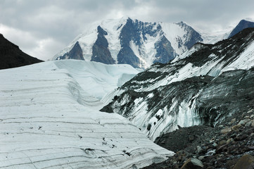 Powerful glacier against the backdrop of the peak of the mountain. Maashey-Bash Peak and Maashey...