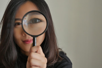 woman searching, viewing, finding with magnifying glass, girl searching concept