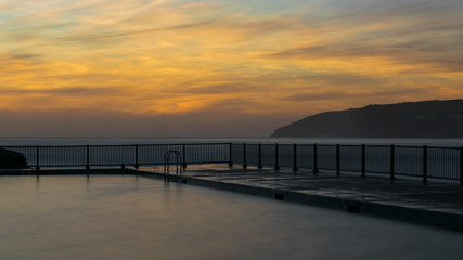 Fototapeta na wymiar Long exposure of Queenscliff Rock Pool at Manly Beach shortly after sunrise - Sydney, Australia