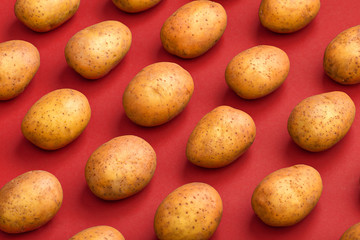 Fototapeta na wymiar Potato on a colored background. Pattern of potato. Natural potato