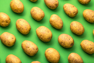 Potato on a colored background. Pattern of potato. Natural potato