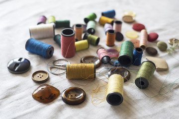 Sewing supplies on a white fabric