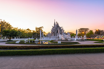Wat Rong Khun(White temple)at sunset in Chiang Rai,Thailand.23/01/2018 Wat Rong Khun is modern building, well known worldwide.It was designed by Chalermchai Kositpipat.Opened it to visitors in 1997.