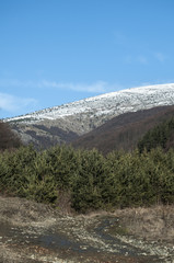 Mountain landscape and country road on clear sunny winter day