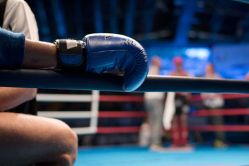 Muaythai boxer hand on the ring rope during the break