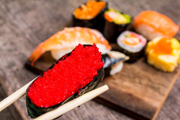 Top view,Sushi Set sashimi and sushi rolls served on wood slate.Copy space for your text.