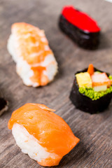 Sushi Set sashimi and sushi rolls served on wood slate