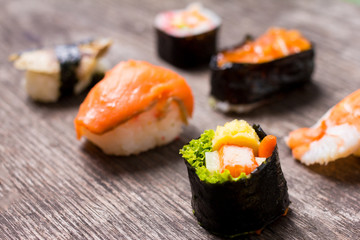 Sushi Set sashimi and sushi rolls served on wood slate