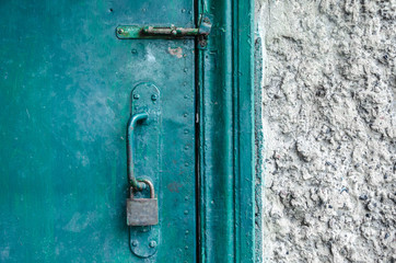 textured door handle with lock, on the old green door