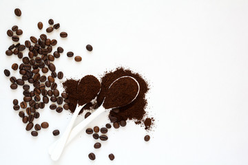 Background with assorted coffee:  coffee beans and powder on white background. Space for copy. Top view. Flat lay