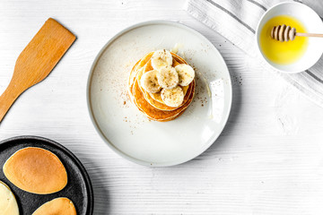 cooked pancake on plate top view at wooden background