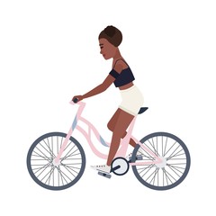 Fototapeta premium Cute smiling teenage girl dressed in shorts and top riding bicycle