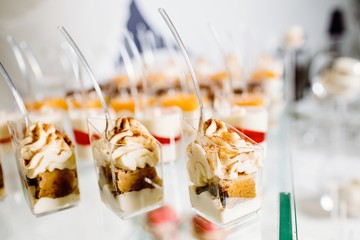 Wedding reception dessert table with delicious decorated white c