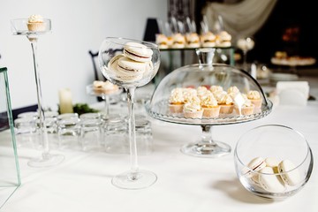 Wedding reception dessert table with delicious decorated white c