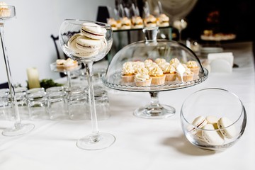 Wedding reception dessert table with delicious decorated white c