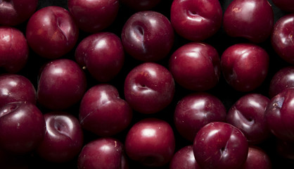 plums on black background