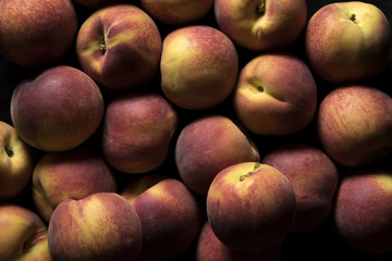 yellow peaches on black background
