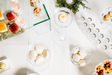 Fototapeta na wymiar Wedding reception dessert table with delicious decorated white c