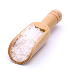 Sea salt in wooden scoop isolated on white background
