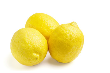 Three yellow ripe lemon fruit, isolated on a white background