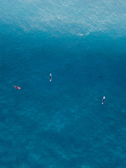Fototapeta na wymiar Aerial view of groups of surfers in the water.