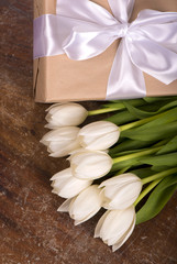 White tulips on wooden background