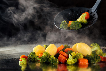 Steamed vegetables on tray.