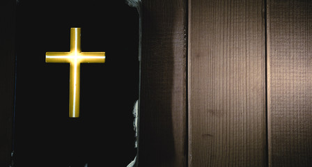 Light of cross on holy bible with wooden.Christian, Christianity, Religion background.