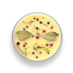 Chicken liver pate covered with melted butter and decorated with bay leaves and black and red pepper isolated on white background. Top view.