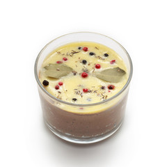 Chicken liver pate jar covered with melted butter isolated on white background.
